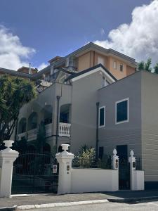 a large house with a fence in front of it at Scirocco - Villa Marina in Marina di Andora