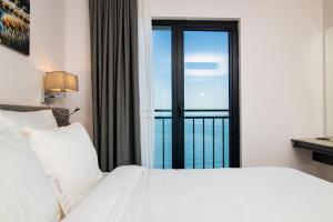 a bedroom with a white bed and a large window at Best Western Plus Trabzon in Trabzon +68 photos