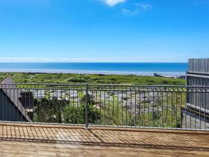 a balcony with a view of the ocean at Pendine Beach Apartment in Pendine