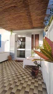 a porch with a white couch on a patio at Kanela Guest House B-side in Machico +69 photos