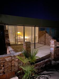 a building with a brick wall and windows at night at Casamora in Edremit