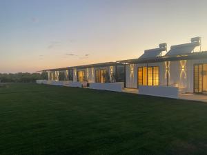 a large building with a green lawn in front of it at Casamora in Edremit