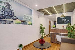 a lobby of a spa with a statue on the wall at RCC Hotels Parkview Inn Miyapur in Lingampalli