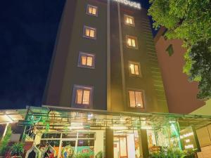 a tall building with lights in front of a store at RCC Hotels Parkview Inn Miyapur in Lingampalli
