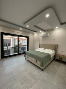 a bedroom with a large bed and a large window at Master Vi in Dalaman +25 photos