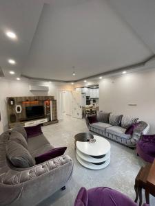 a living room with two couches and a table in it at Master Vi in Dalaman