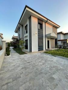a large house with a driveway in front of it at Master Vi in Dalaman