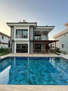 a house with a swimming pool in front of a house at Master Vi in Dalaman