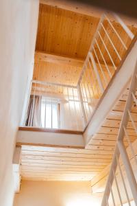a wooden staircase in a house with a window at Locanda dell'Ortolano in Ferrara