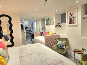 a bedroom with a bed and a living room at Stylish & Central Design Apartment- 3 Beds in Edinburgh