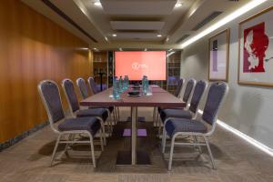 a conference room with a table and chairs and a screen at Hotel Starc by Pierre & Vacances Premium in Andorra la Vella