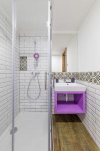 a bathroom with a purple sink and a shower at Artkazal in Mórahalom