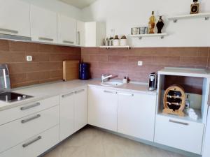a kitchen with white cabinets and a sink at Apartman Katić - Rental Home in Stolac
