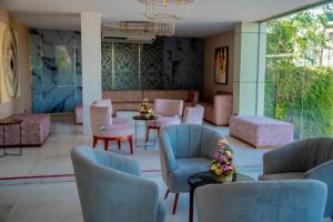 a lobby with chairs and tables and a waiting room at Lavendish Hills Kandy in Kandy