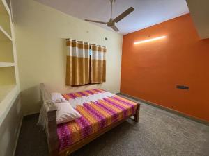 a room with a bed in a room with a window at Vignesh Home staying in Tiruvannāmalai