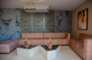 a living room with a couch and a table at Lavendish Hills Kandy in Kandy