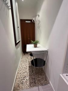 a bathroom with a sink and a chair in a hallway at Comfort Room in Treviso
