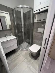 a bathroom with a shower and a toilet and a sink at Comfort Room in Treviso