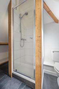 a shower with a glass door in a bathroom at 4 Bed in Pentewan oc-edghil in Pentewan