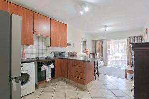 a kitchen with a washer and dryer at Calmwood Stay in Midrand