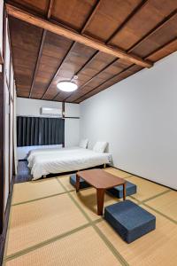 a bedroom with a bed and a coffee table at YAGARA TERRACE HOUSE OSAKA Room B in Osaka