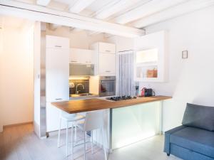 a kitchen with white cabinets and a wooden counter top at Venice Entry Comfort Apartment in Mestre