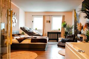 a living room with a bed and a couch at Wellness Suite mit Whirlpool und Sauna in Ahlen
