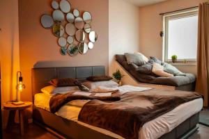 a bedroom with two beds and a couch at Wellness Suite mit Whirlpool und Sauna in Ahlen