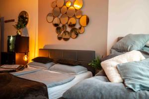 a living room with two beds and pots and pans on the wall at Wellness Suite mit Whirlpool und Sauna in Ahlen +28 photos