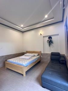 a room with a bed and a couch in it at An's House - Đóng trên booking - LH trực tiếp in Phan Thiet