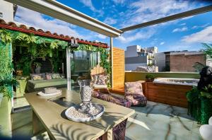 a patio with a table with a vase on it at Fairytale Athens - Luxury Suites in Athens