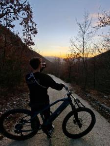 a man is riding a bike on a road at Agriturismo Le Case di Quarantotti in Norcia