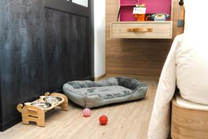 a bedroom with a dog bed and toys on the floor at Moxy Bangkok Ratchaprasong in Bangkok +72 photos