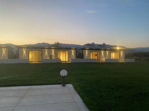 a large white house with the sunset in the background at Casamora in Edremit