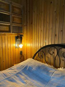 a bedroom with a bed in a wooden wall at Casamora in Edremit