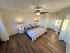 a bedroom with a bed and a ceiling fan at Spacious & Private Retreat near West Edmonton Mall in Edmonton