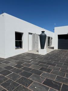 a large vase sitting on the side of a building at Studio on Main in Langebaan