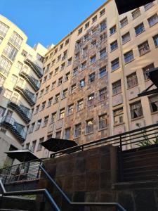 a large brick building with stairs in front of it at Mapungubwe hotel unit 525 in Johannesburg