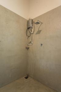 a room with a wall with a camera on the wall at Villa Pigeon Paradise in Unawatuna