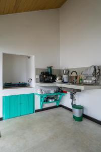 a kitchen with green cabinets and a counter top at Villa Pigeon Paradise in Unawatuna +17 photos