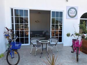 a patio with three bikes and a table and chairs at Studio Thakhek-private loft with terasse in Thakhek