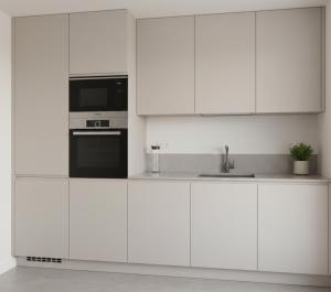 a white kitchen with white cabinets and a microwave at anka ra 06 in Dikmen +11 photos