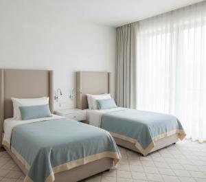 a bedroom with two beds and a window at anka ra 06 in Dikmen
