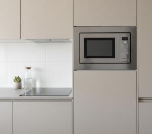 a kitchen with a microwave above a counter at anka ra 06 in Dikmen