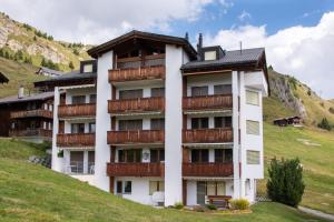 a building with balconies on the side of a hill at Apartment Weisshorn in Riederalp