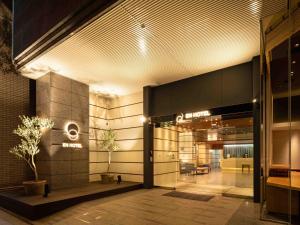 a lobby of an office building with a sign on it at EN HOTEL Hamamatsu in Hamamatsu