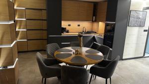 a dining room with a table and chairs in a kitchen at Luxury Apartments TRED in Pleven +29 photos
