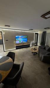a large living room with a large tv on a wall at Luxury Apartments TRED in Pleven