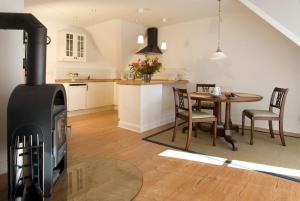 a kitchen and living room with a wood stove at Clara Elisabeth in Döhnsdorf