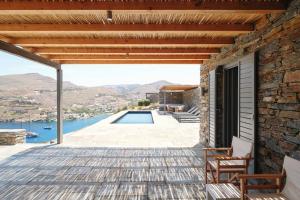 a stone house with a swimming pool at Kymo Kea in Otziás